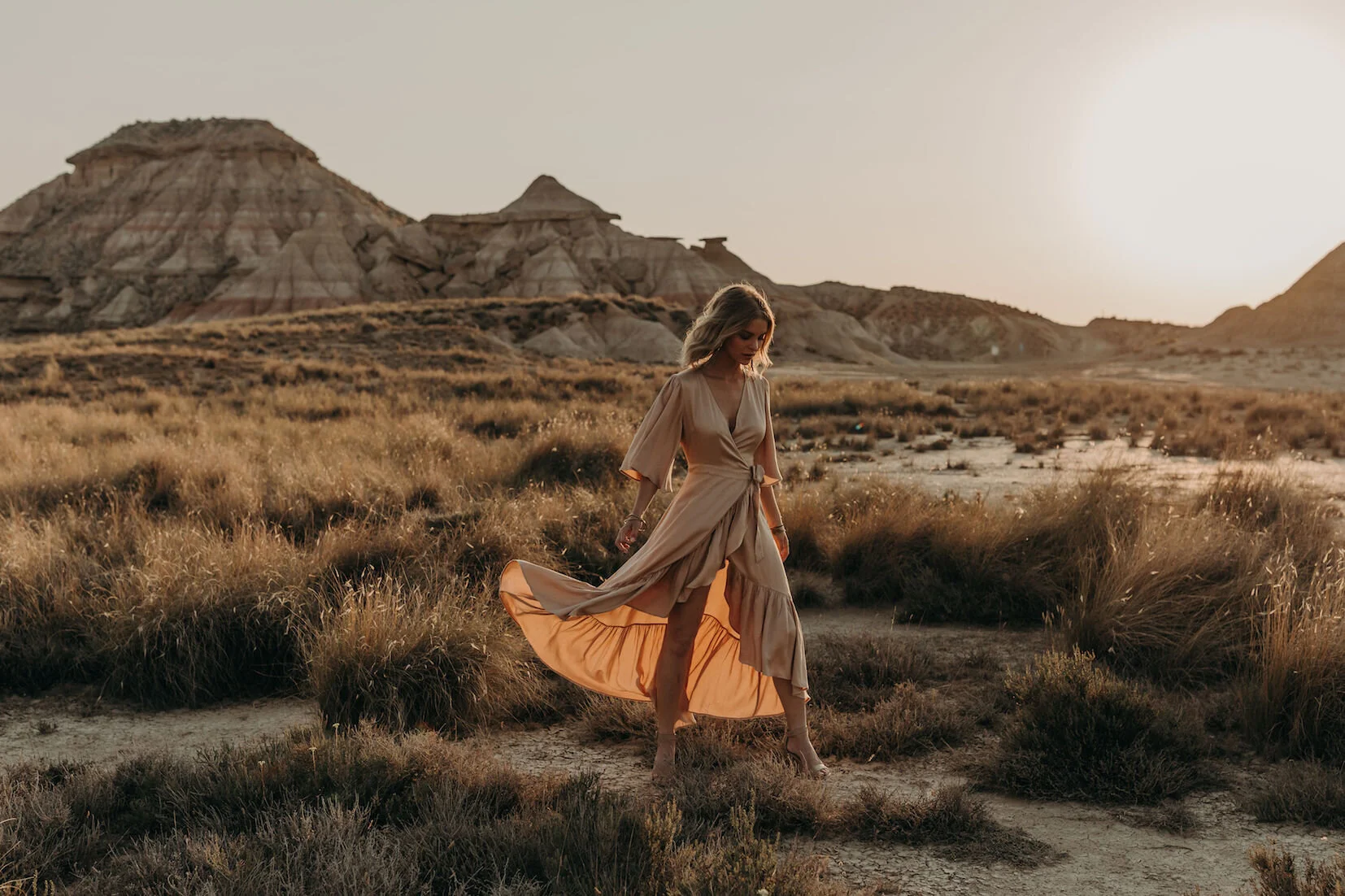 Woman walking on sand dune
